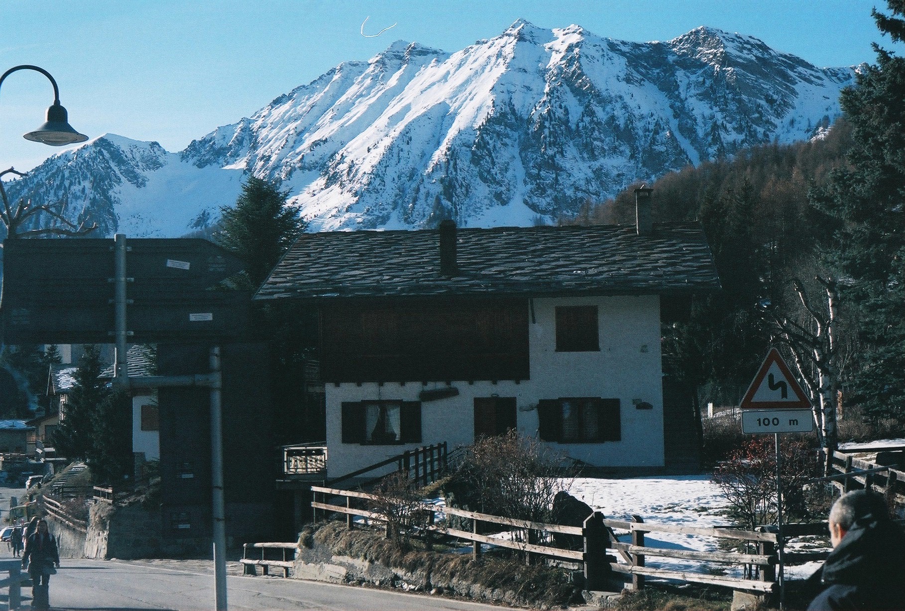 Alpine chalet beneath snow-capped peaks
